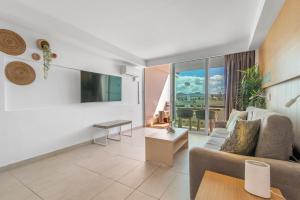 a living room with a couch and a table at Be Room Bronze Suite in Playa del Ingles