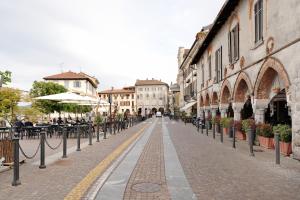 an empty street with tables and chairs and buildings at Casa Perry - Lago Maggiore in Borgo Ticino