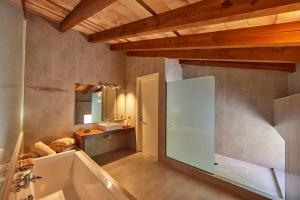 łazienka z wanną, umywalką i lustrem w obiekcie Ca' n Beia Suites - Adults Only w mieście Alaró
