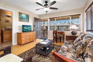 a living room with a couch and a table at Kona Shores 221 STVR #19-390879 in Kailua-Kona