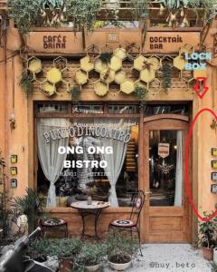 a restaurant with a table in front of a building at Langmandi Experience Ấu Triệu in Hanoi