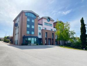 a large building with a clock on top of it at don guglielmo panoramic hotel & spa in Campobasso