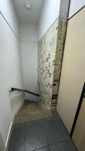 a small bathroom with a wall with newspapers on it at COACHHOSTEL7 in Sao Paulo
