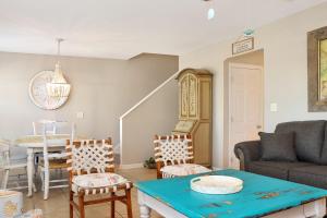 a living room with a couch and a table and chairs at The Palms 2B by Pristine Property Vacation Rentals in Mexico Beach