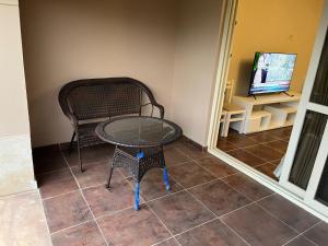 a table and a chair and a television in a room at La vista topaz in Ain Sokhna