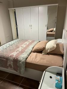a bedroom with a bed with white cabinets and a sink at La vista topaz in Ain Sokhna +19 photos