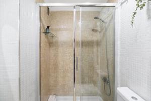 a shower with a glass door in a bathroom at Casa Pepe in Jerez de la Frontera +16 photos