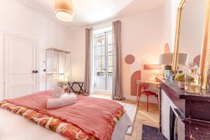 a bedroom with a bed and a desk and a mirror at Joséphine la Nantaise - En bail mobilité in Nantes