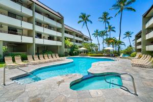 a swimming pool in front of a hotel at White Sands Village#231 in Kailua-Kona
