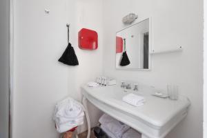 a white bathroom with a sink and a mirror at G House in Venice