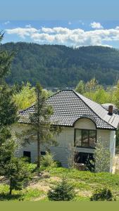 a house with a tiled roof on top of it at RIVIERA in Lekechi