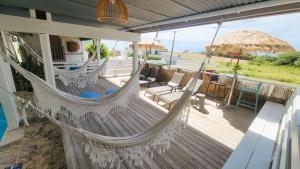 a porch with a hammock and a view of the ocean at La Jamaca - An Island Vibe Hotel in La Parguera