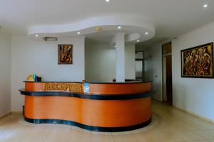 a lobby with a reception counter in a building at Nobilis Hotel and Apartments in Kigali