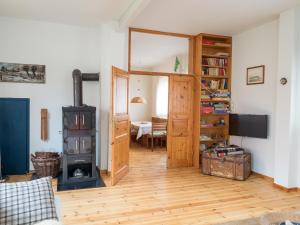 a living room with a door and a wood stove at Alte Wäscherei in Spiekeroog