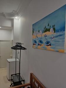 a painting of boats on the wall in a room at adel vacation in Djerba