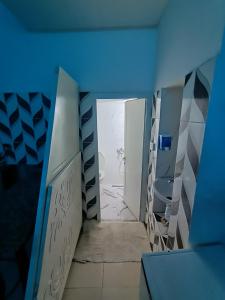 a blue room with a bathroom with a toilet at adel vacation in Djerba