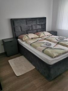 a bedroom with a large bed with a large headboard at Apartman Juric in Posušje