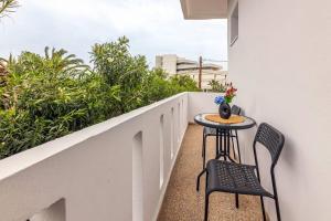 a small table and two chairs on a balcony at Fysalida's Coastal Gem 4 - Steps Away from the Sea in Heraklion