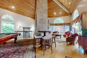 a living room with a pool table and a living room with at Villa Rosa in Lake Lure