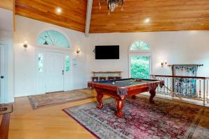 a living room with a pool table and a tv at Villa Rosa in Lake Lure