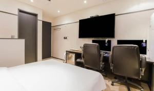 a hotel room with a bed and a desk and a tv at Incheon Browndot Hotel Nonhyeon Soraepogu in Incheon