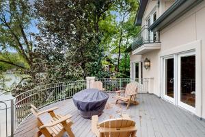 a patio with chairs and a table on a balcony at Villa Rosa in Lake Lure