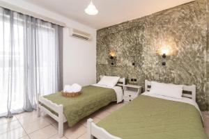 Posteľ alebo postele v izbe v ubytovaní Amarylis Beachfront Studios