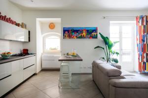 a kitchen with a couch and a table in a room at Tomasi Apartment Palermo in Palermo