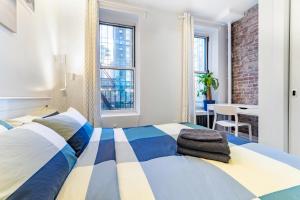 a bedroom with a blue and white bed and a desk at 2 Bedroom Luxury Unit in the Heart of Manhattan in New York