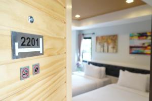 Postel nebo postele na pokoji v ubytování Ma Non Nont Hotel & Apartment