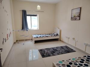a living room with a couch and a window at New! Relaxing Family Home just 8 mins to waterfront in Sharjah