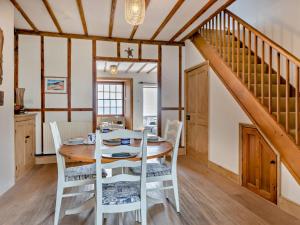 a dining room with a table and chairs and a staircase at 3 Bed in Torcross 93956 in Torcross