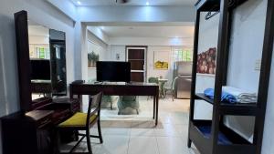 a living room with a desk with a television in it at Artgarden Juan dolio in Juan Pedro