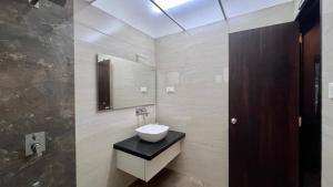 a bathroom with a sink and a mirror at VARDHAN CORPORATE STAY in Pune