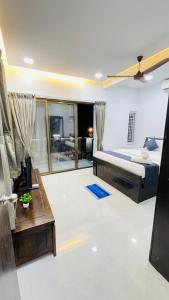 a bedroom with a bed and a table in a room at VARDHAN CORPORATE STAY in Pune