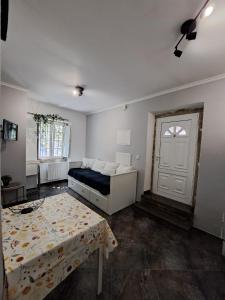 a bedroom with a bed and a table and a door at Casa Cor de Rosa in Lisbon