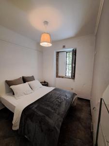 una camera da letto con un grande letto bianco con una finestra di Casa Cor de Rosa a Lisbona