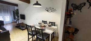 a dining room with a table and a butterfly on the wall at El Rincon de Ale in Cuenca