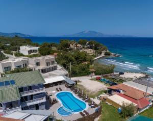 an aerial view of a resort with a swimming pool and the ocean at Amarylis Beachfront Studios in Amoudi