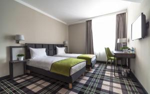 Postel nebo postele na pokoji v ubytování Hotel Impresja