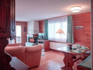 a living room with a couch and a table at Apartment Ambassadeur 1 by Interhome in Villars-sur-Ollon