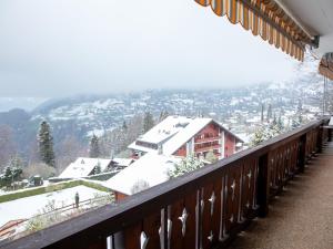 a balcony with snow on the roofs of buildings at Apartment Ambassadeur 1 by Interhome in Villars-sur-Ollon