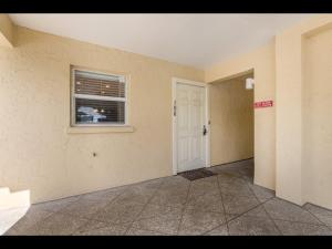a empty room with a door and a window at 4200 GULF DRIVE UNIT 108 home in Holmes Beach