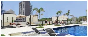 a rendering of a swimming pool with chairs and a building at ApartaSuite 932 en Porto Horizonte SANTA MARTA in Santa Marta