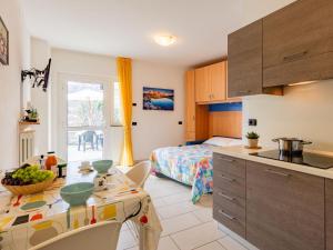 a kitchen and a bedroom with a bed and a table at Apartment Raggio di Sole Apartment A by Interhome in Consiglio di Rumo