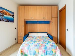 a bedroom with a bed and wooden cabinets at Apartment Raggio di Sole Apartment A by Interhome in Consiglio di Rumo +20 photos