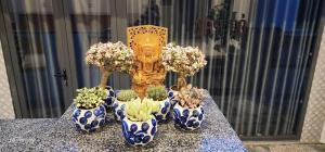 four blue and white vases with flowers in them on a table at Homestay Cỏ trên Mây in Liên Trì (4) +14 photos