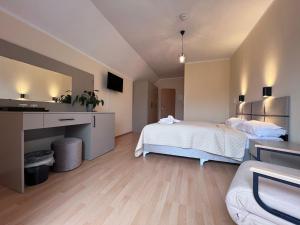 a bedroom with a bed and a sink and a mirror at La Melis in Geldern