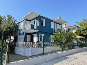 a blue house with a fence in front of it at Merkezde denize 5 dakika villa in Kusadası