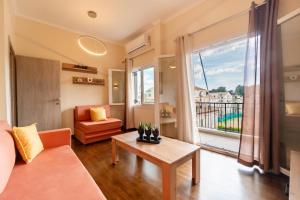 a living room with a couch and a table at Tennis View Apartment in Agios Rokkos